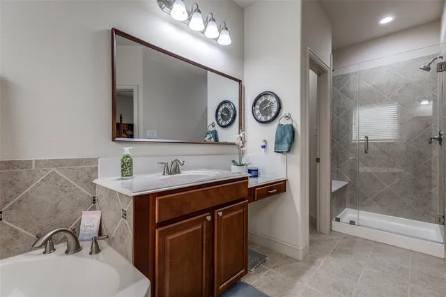 a bathroom with a sink a mirror and a shower