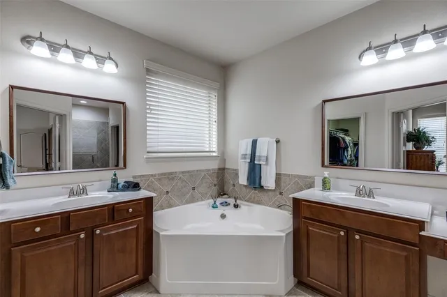 a bathroom with a sink double vanity and a mirror