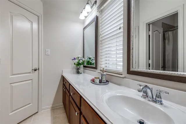 a bathroom with double vanity and a mirror