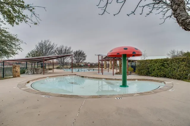 a view of a swimming pool with a yard