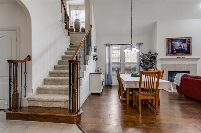 a view of a dining room with furniture a chandelier and wooden floor