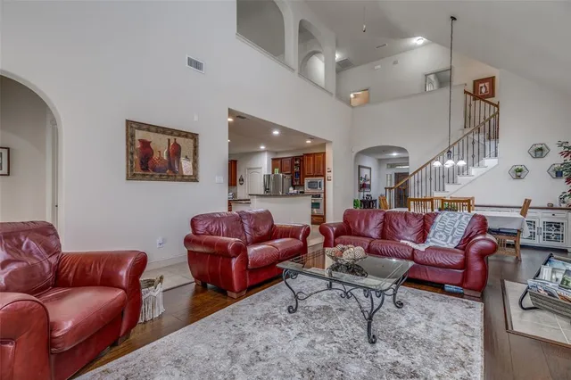 a living room with furniture a rug and white walls