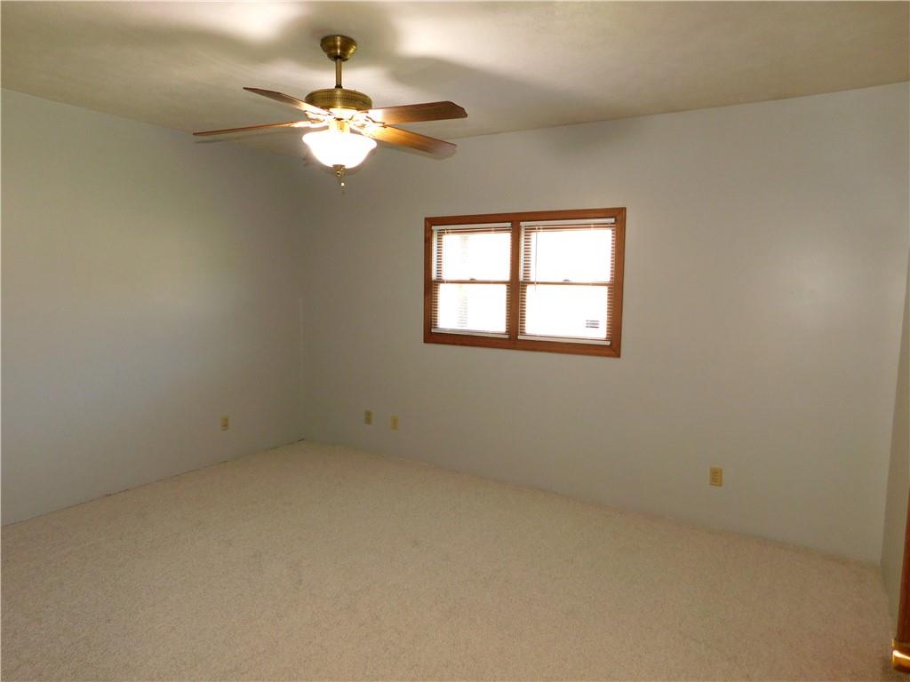 425 Vaneal Road Washington, PA 15301 - Photo 14 of 24 an empty room with a chandelier fan and windows