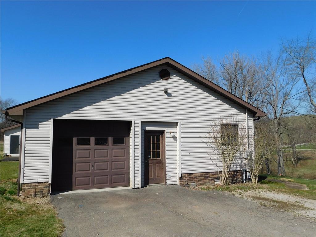 425 Vaneal Road Washington, PA 15301 - Photo 5 of 24 a front view of a house with a garage