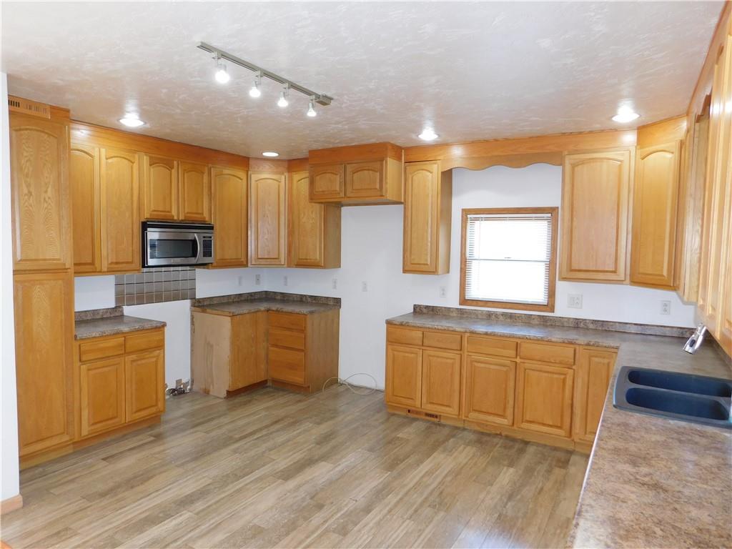 425 Vaneal Road Washington, PA 15301 - Photo 6 of 24 a large kitchen with cabinets wooden floor and stainless steel appliances