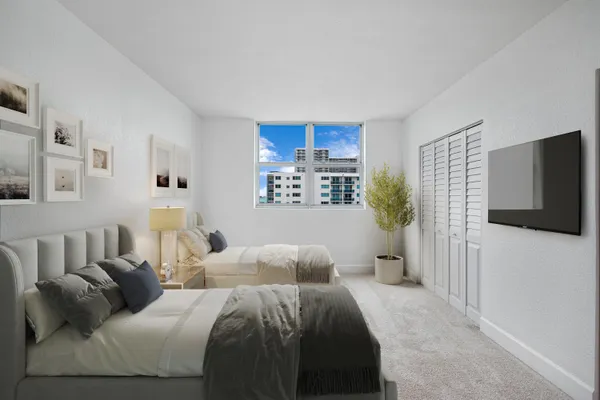 a bedroom with a balcony a bed and a flat screen tv