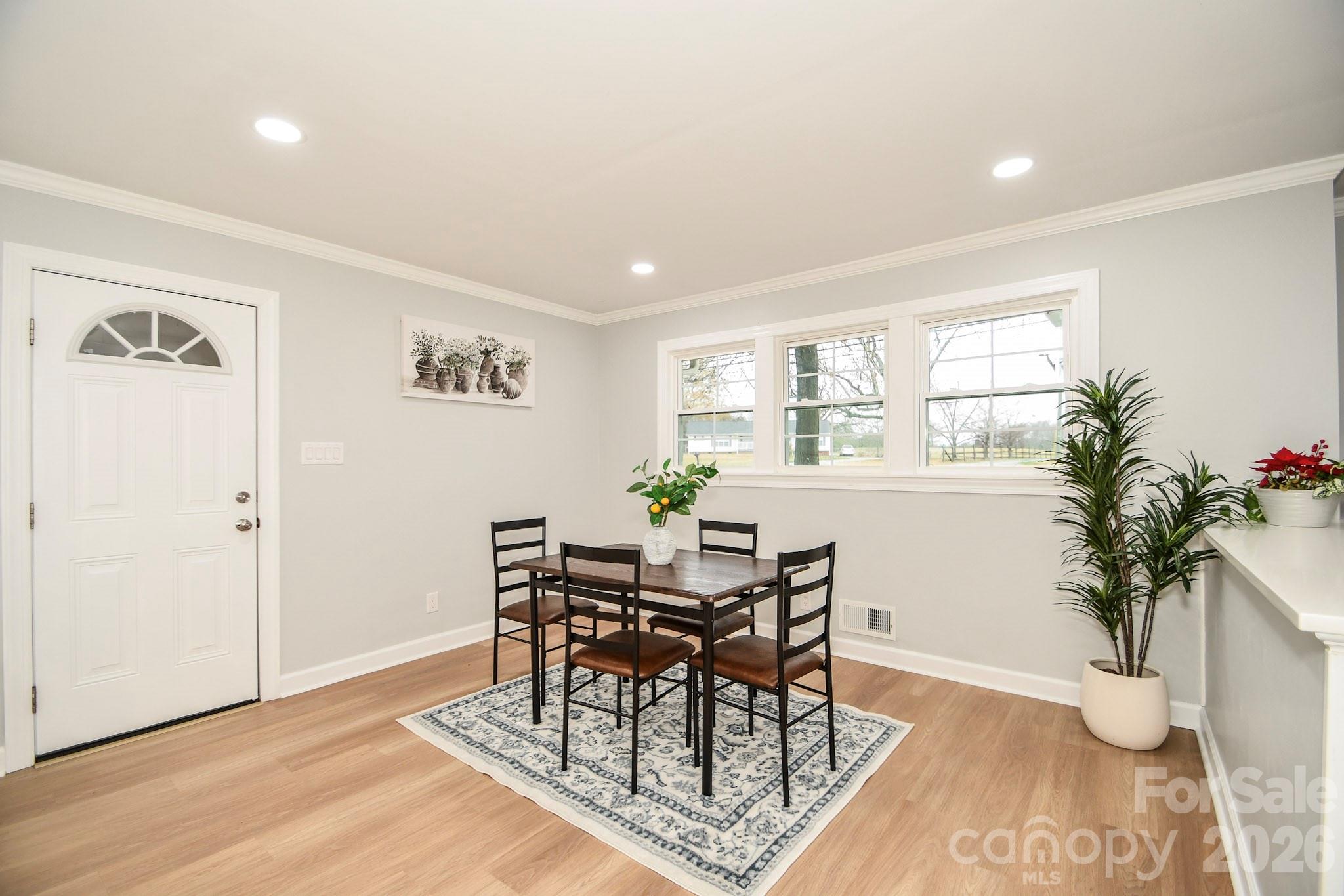 4517 Plyler Mill Road Monroe, NC 28112 - Photo 14 of 37 a view of a dining room with furniture and a potted plant