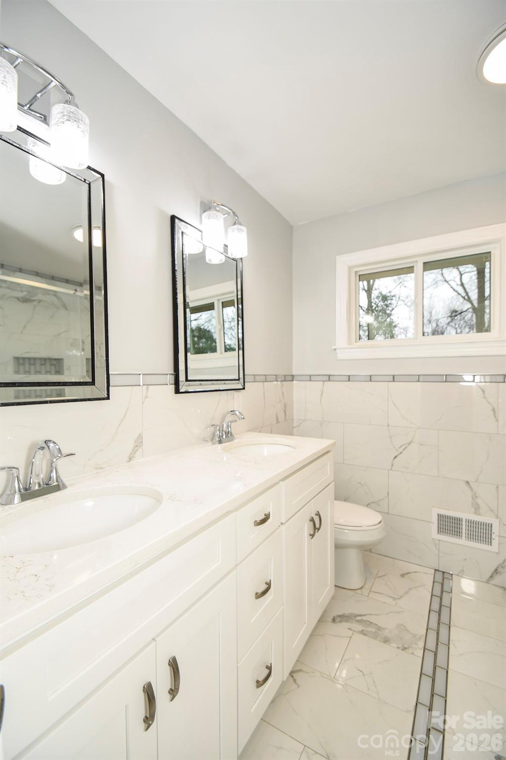 4517 Plyler Mill Road Monroe, NC 28112 - Photo 22 of 37 a bathroom with a toilet sink and mirror