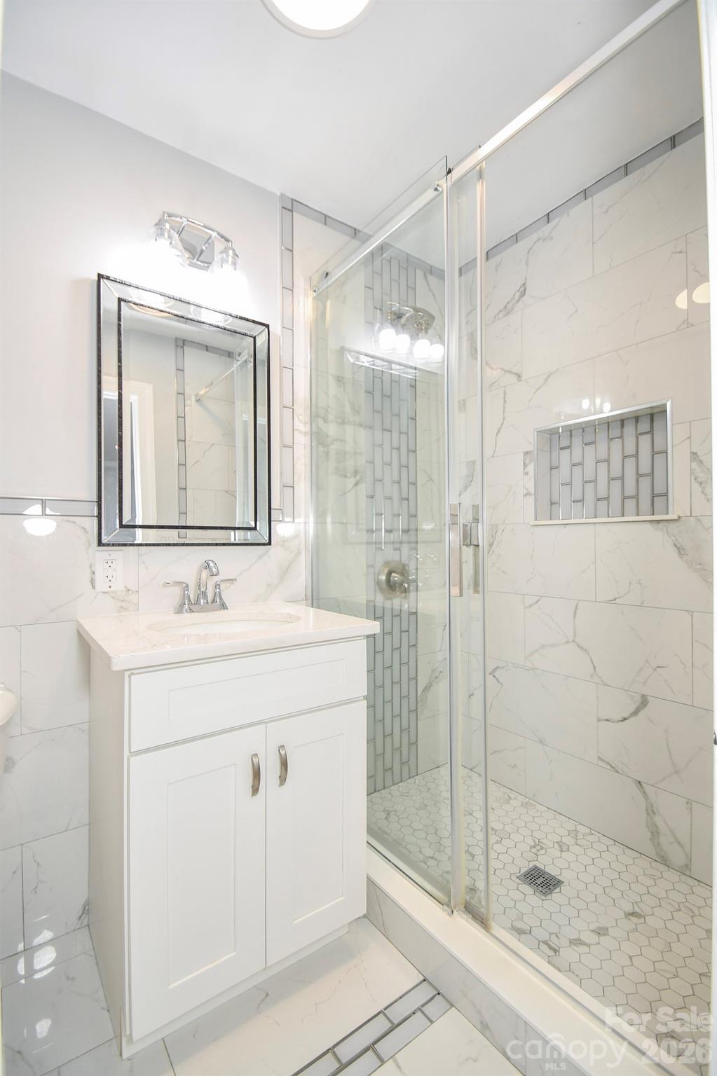 4517 Plyler Mill Road Monroe, NC 28112 - Photo 25 of 37 a bathroom with a shower sink and mirror