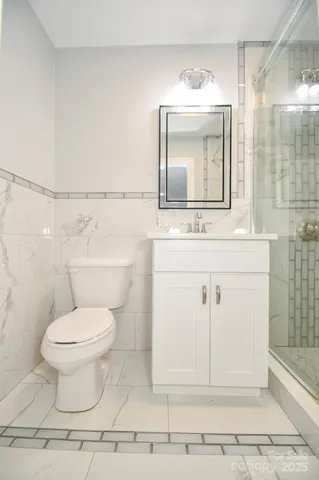 a bathroom with a sink toilet and mirror