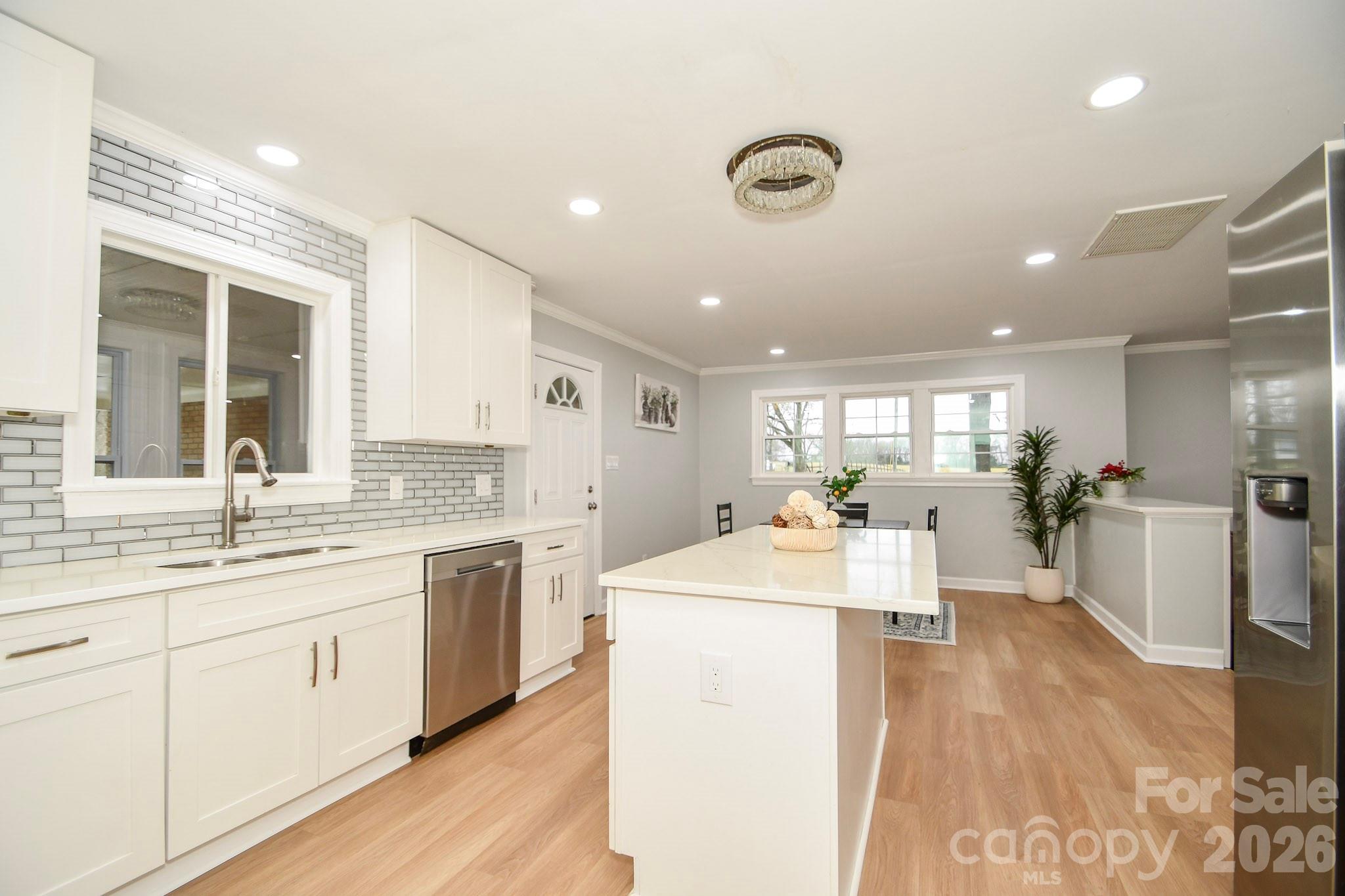 4517 Plyler Mill Road Monroe, NC 28112 - Photo 29 of 37 a large kitchen with kitchen island a sink stainless steel appliances and cabinets