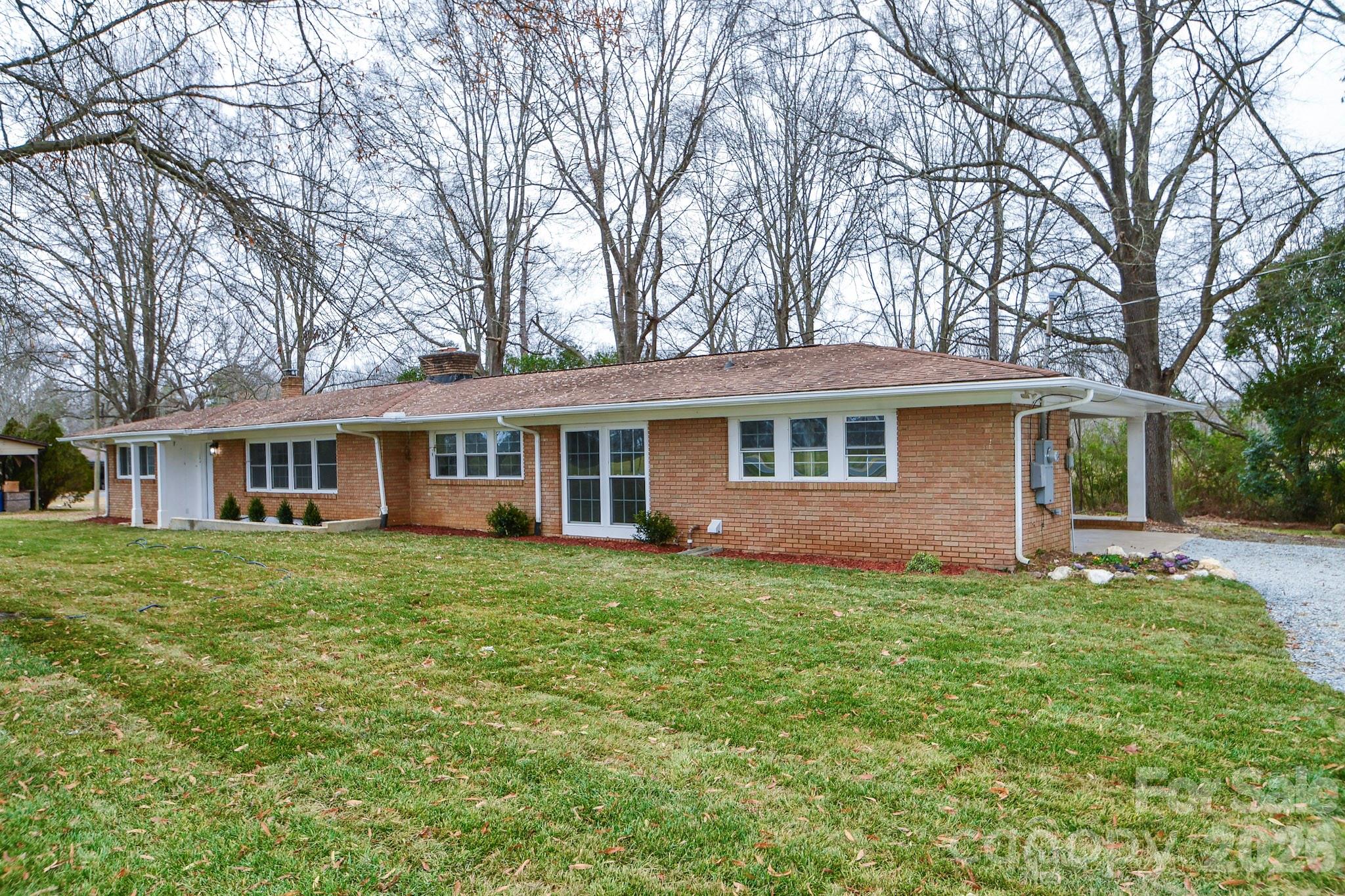 4517 Plyler Mill Road Monroe, NC 28112 - Photo 3 of 37 a front view of a house with a garden
