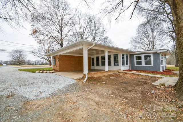 a view of a house with a yard and sitting area