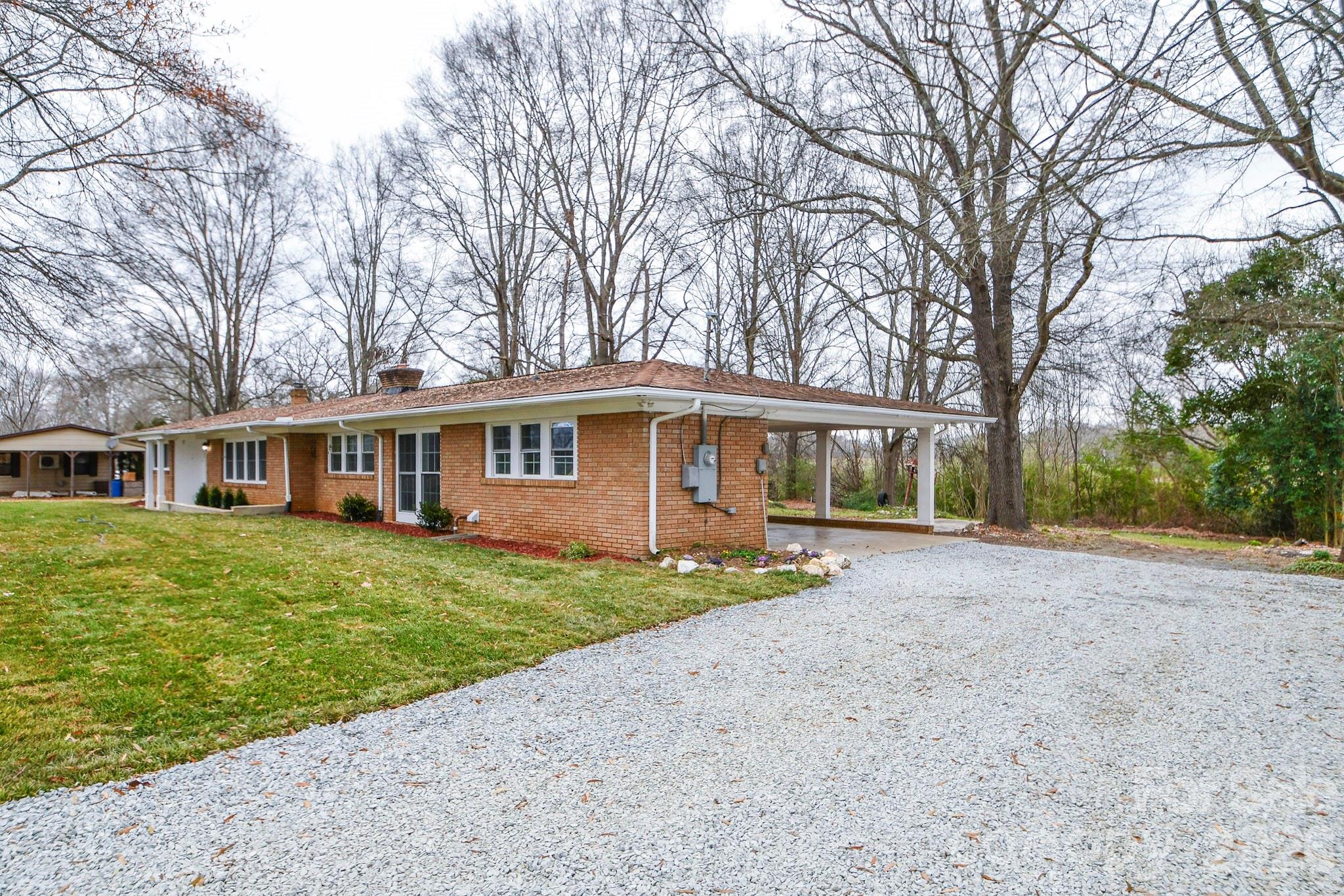 4517 Plyler Mill Road Monroe, NC 28112 - Photo 4 of 37 a front view of a house with a garden