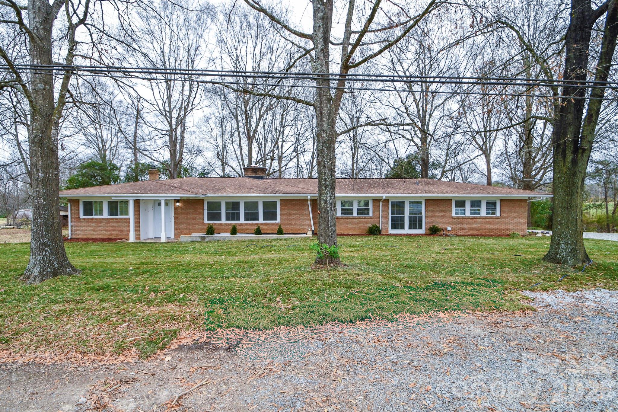 4517 Plyler Mill Road Monroe, NC 28112 - Photo 5 of 37 a front view of a house with a garden