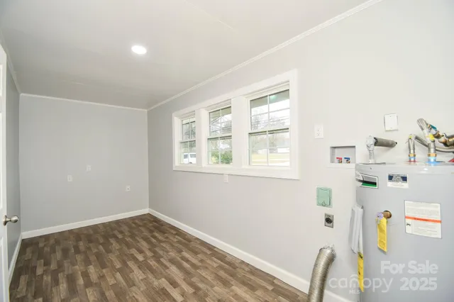 a view of a bedroom with a bed and a window