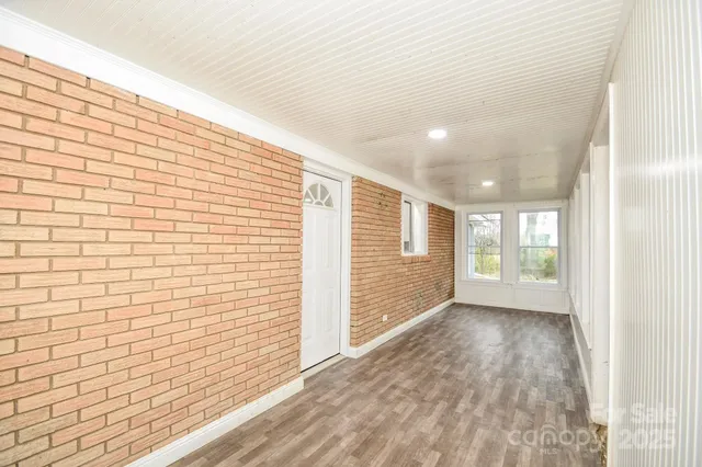 a view of an empty room and a window