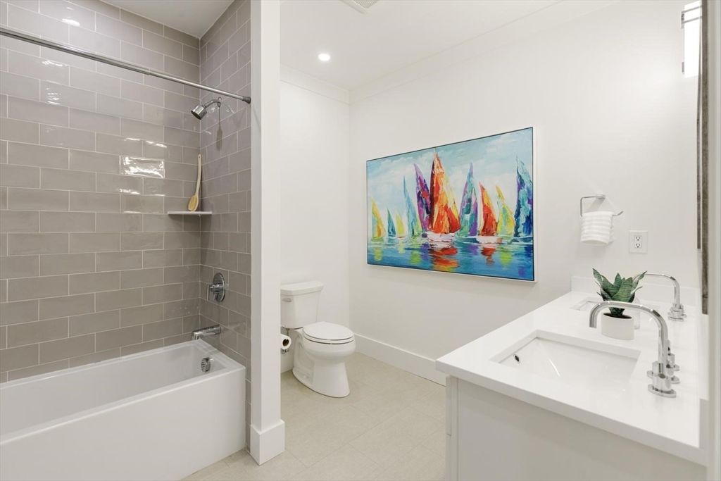 1124 Chestnut Street Newton, MA 02464 - Photo 23 of 41 a bathroom with a toilet a sink and a bathtub