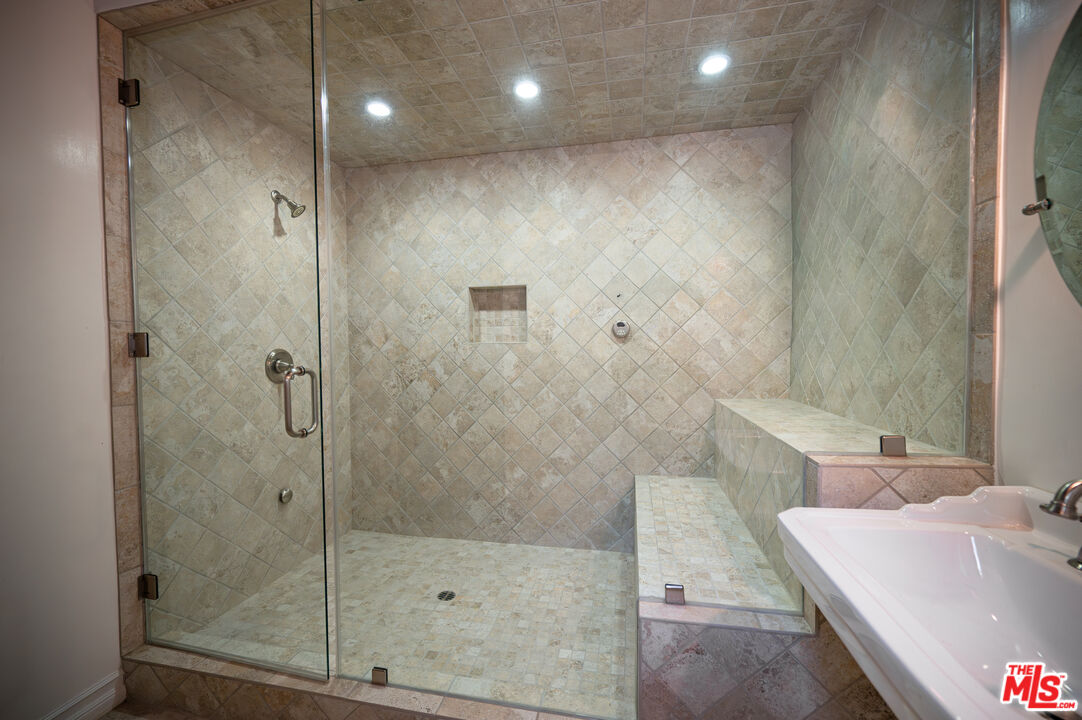 503 North Greencraig Road Los Angeles, CA 90049 - Photo 48 of 59 a bathroom with a tub and a shower