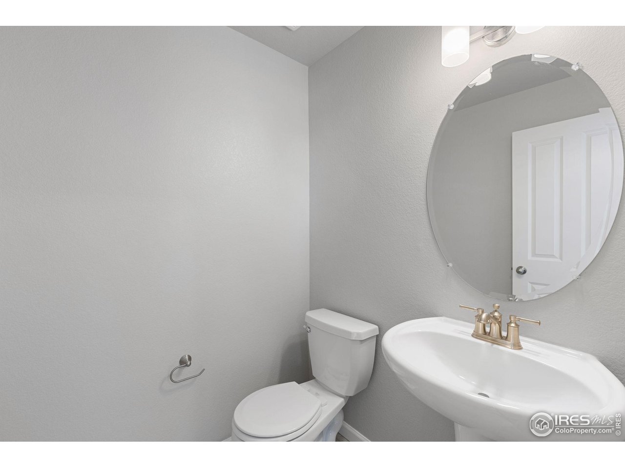 6765 Utica Court Firestone, CO 80504 - Photo 11 of 23 a bathroom with a toilet sink and mirror