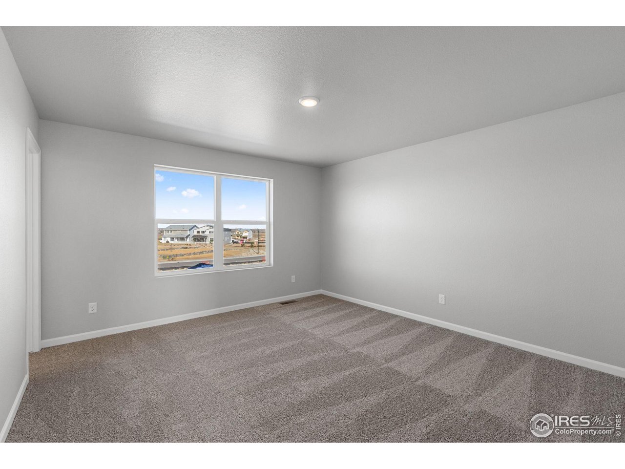6765 Utica Court Firestone, CO 80504 - Photo 12 of 23 a view of an empty room with a window