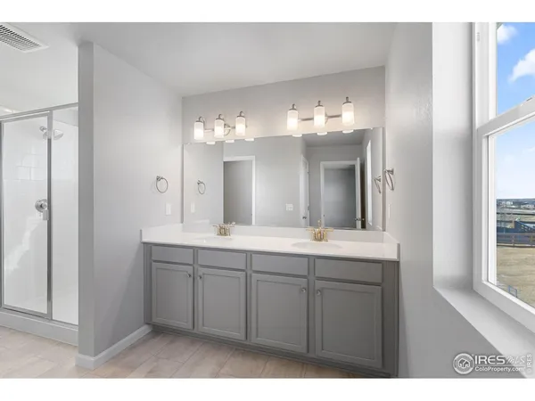 a bathroom with a double vanity sink and a mirror