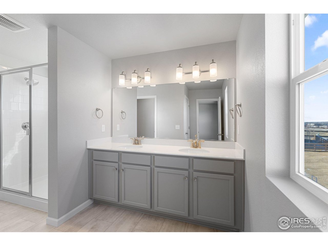 6765 Utica Court Firestone, CO 80504 - Photo 14 of 23 a bathroom with a double vanity sink and a mirror