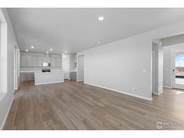 a view of a kitchen with a sink and wooden floor