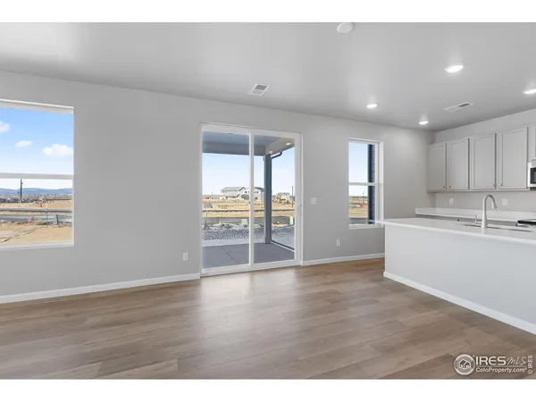 a view of a kitchen with wooden floor