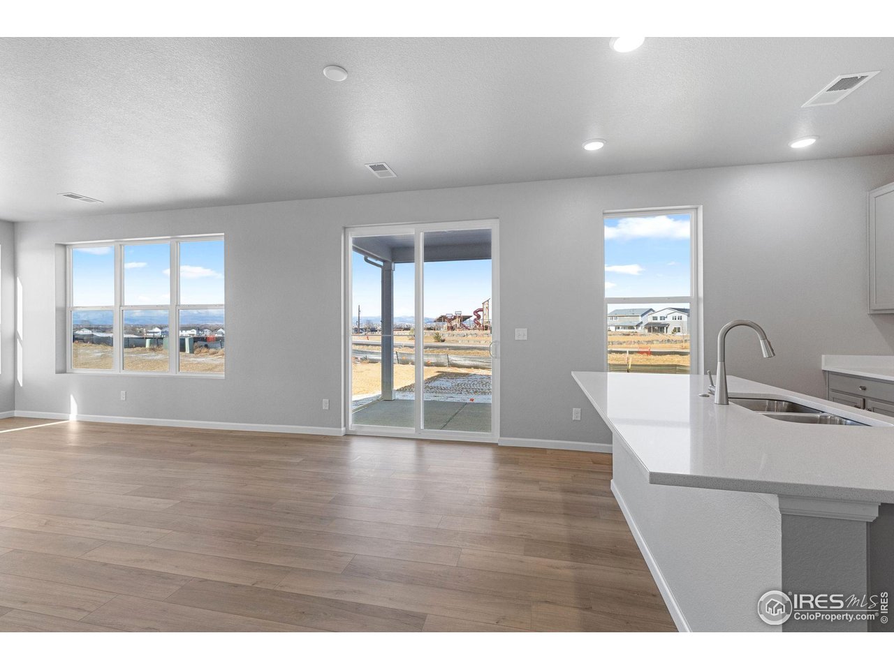 6765 Utica Court Firestone, CO 80504 - Photo 5 of 23 a view hallway with wooden floor and windows