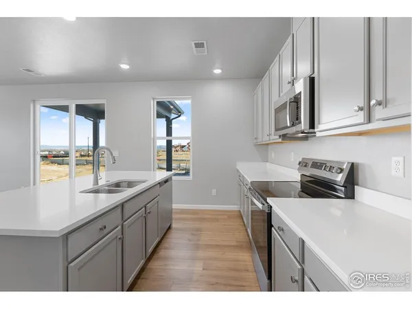 a kitchen with sink and cabinets