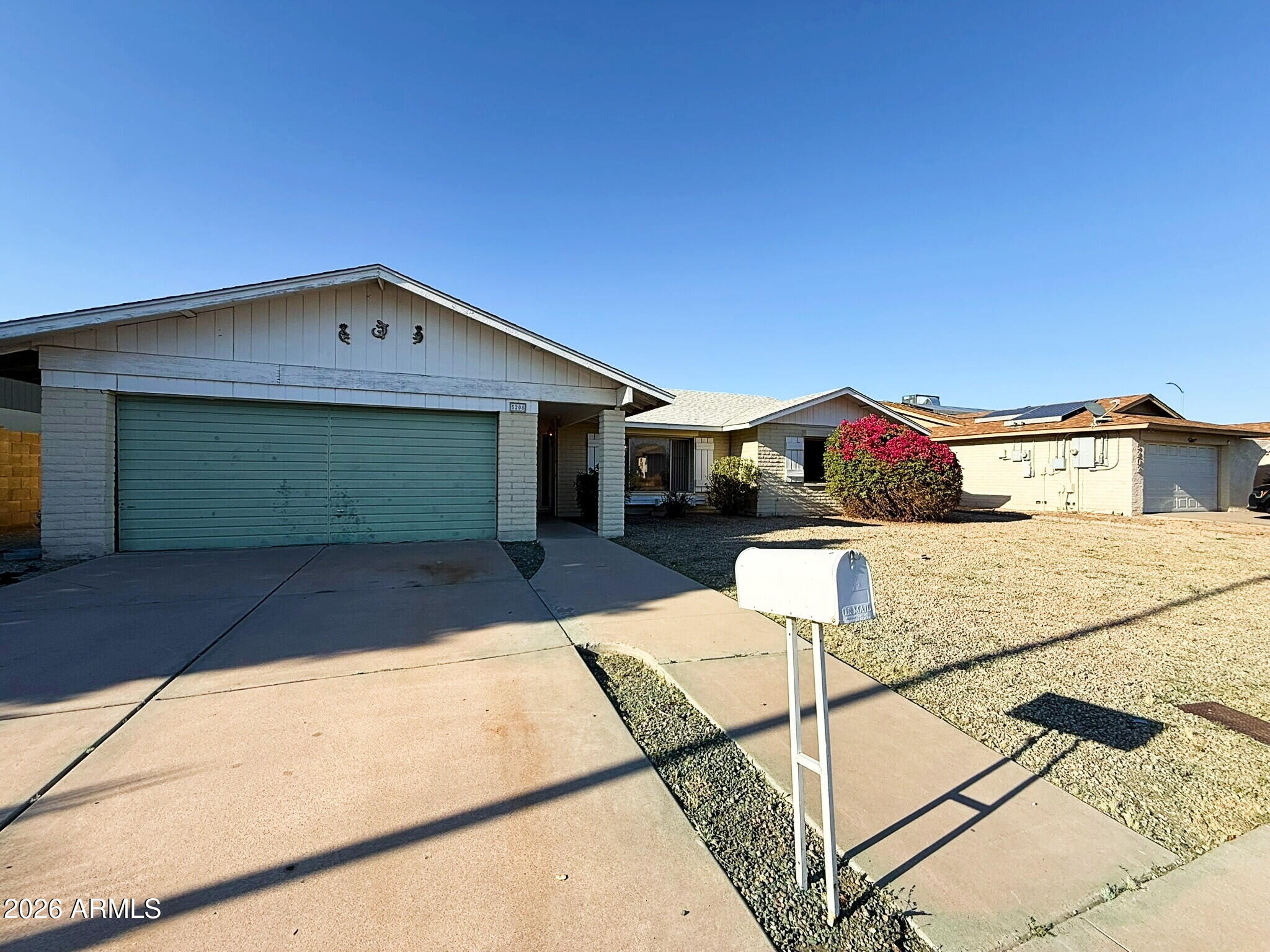 5208 West Calavar Road Glendale, AZ 85306 - Photo 28 of 39 a front view of a house with a yard