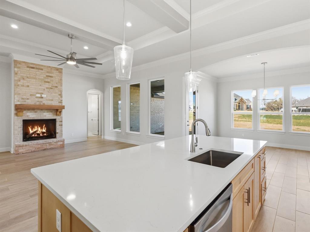 3152 Infinity Drive Weatherford, TX 76087 - Photo 12 of 40 a kitchen with a sink a stove and chairs