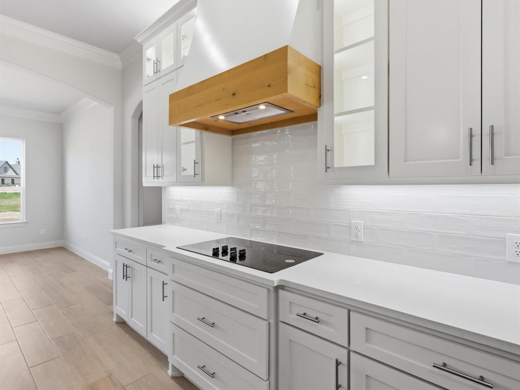 3152 Infinity Drive Weatherford, TX 76087 - Photo 13 of 40 a kitchen with white cabinets and a sink