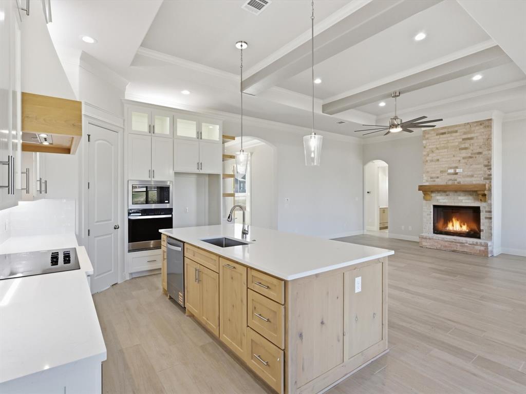 3152 Infinity Drive Weatherford, TX 76087 - Photo 15 of 40 a kitchen that has a lot of cabinets in it and wooden floors