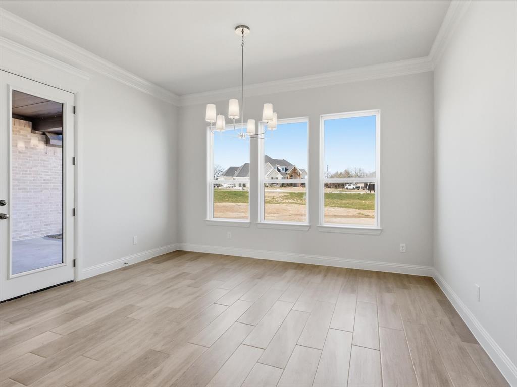 3152 Infinity Drive Weatherford, TX 76087 - Photo 17 of 40 an empty room with wooden floor and windows