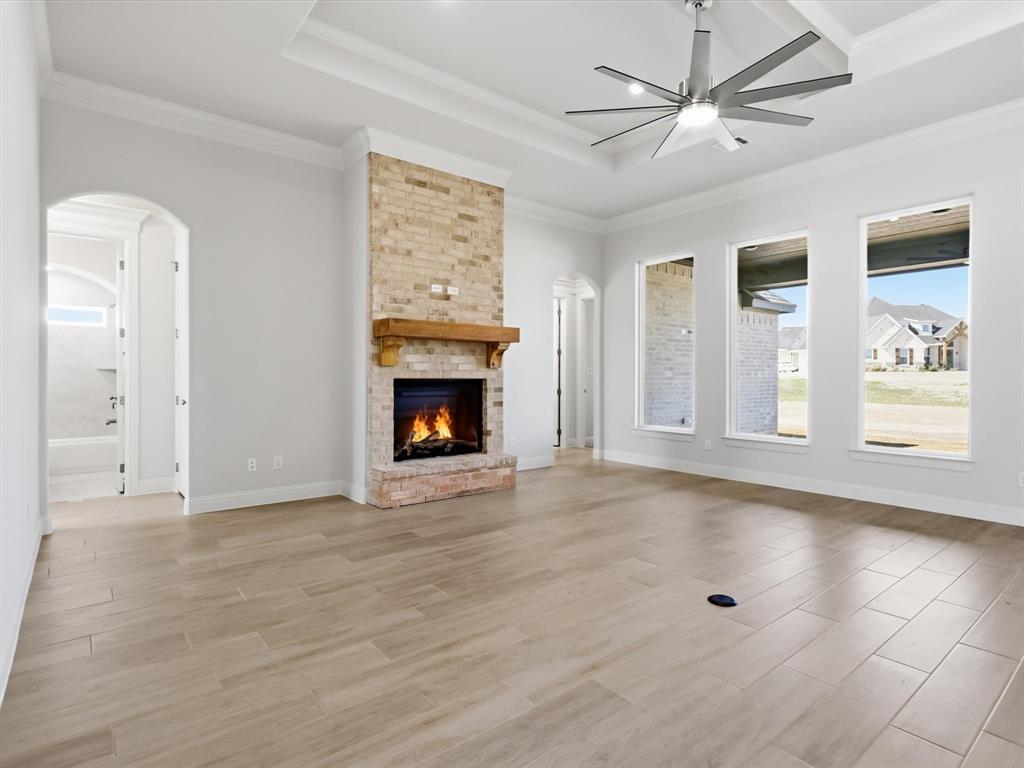 3152 Infinity Drive Weatherford, TX 76087 - Photo 19 of 40 a view of an empty room with a fireplace and a window