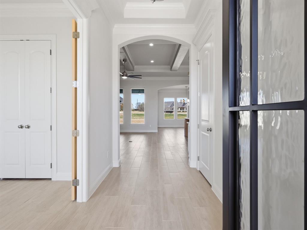 3152 Infinity Drive Weatherford, TX 76087 - Photo 7 of 40 a view of a hallway with wooden floor and staircase