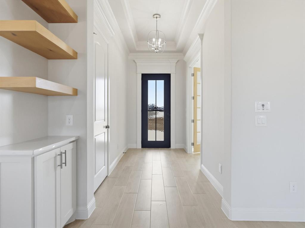 3152 Infinity Drive Weatherford, TX 76087 - Photo 8 of 40 a view of a hallway with a chandelier