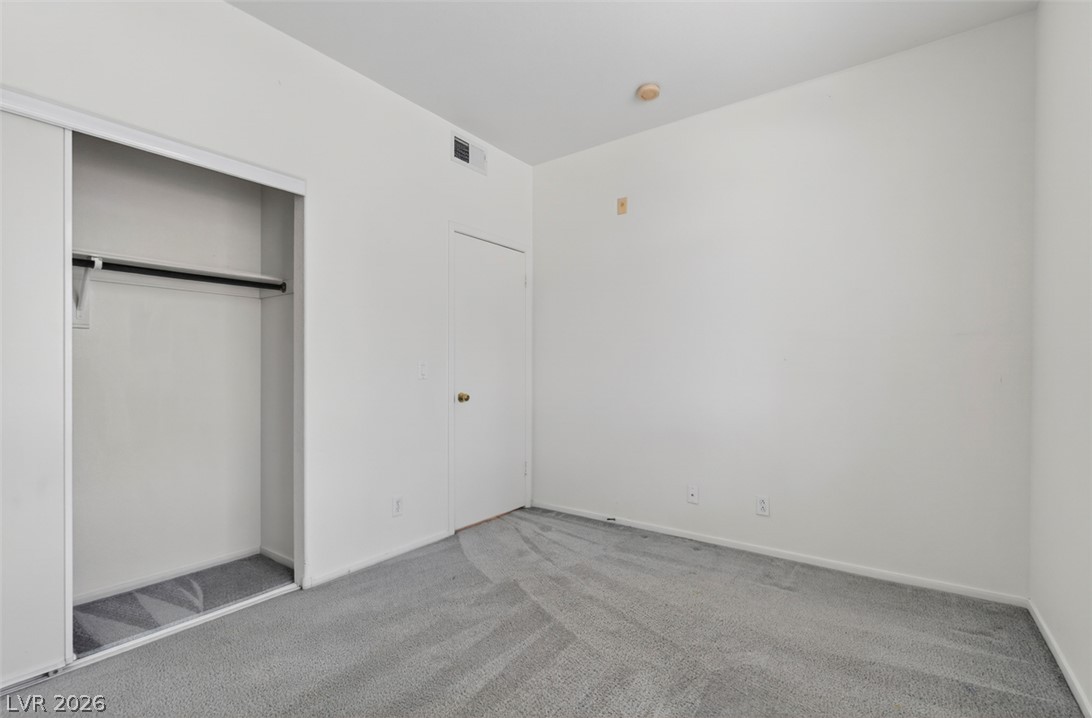 2201 Ramsgate Drive, Unit 1011 Henderson, NV 89074 - Photo 26 of 40 A well-lit room offers fresh carpet and ample closet storage.