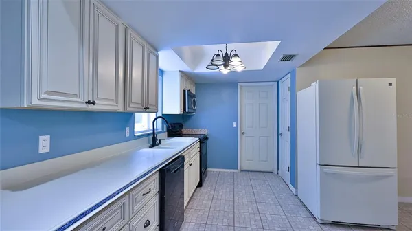 a kitchen with a refrigerator and a sink