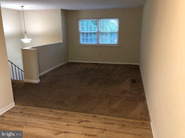 3604 4th Street North Beach, MD 20714 - Photo 6 of 14 an empty room with wooden floor and windows