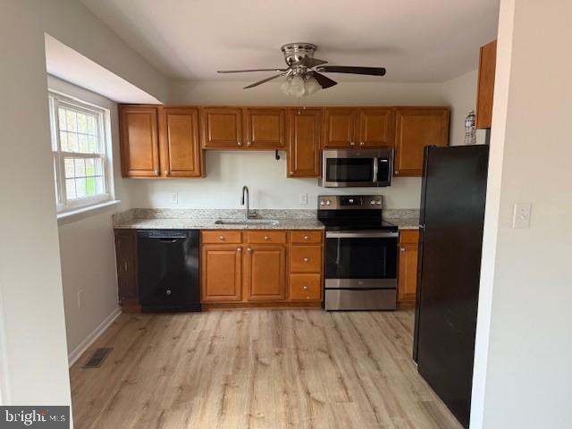 3604 4th Street North Beach, MD 20714 - Photo 7 of 14 a kitchen with stainless steel appliances granite countertop a stove a sink and a refrigerator