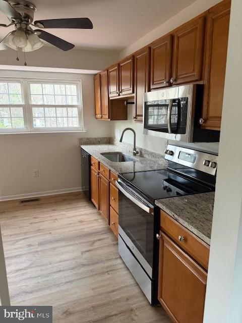 3604 4th Street North Beach, MD 20714 - Photo 9 of 14 a kitchen with stainless steel appliances granite countertop a sink stove and oven