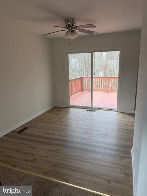 3604 4th Street North Beach, MD 20714 - Photo 10 of 14 a view of empty room with wooden floor and fan