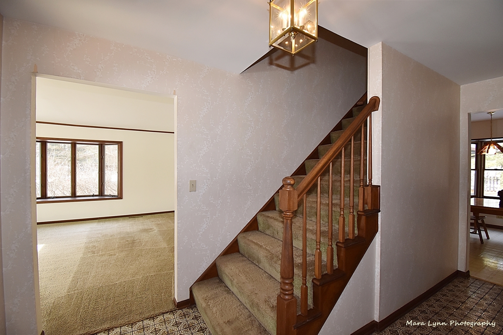 36W818 Oak Road St. Charles, IL 60175 - Photo 3 of 46 a view of staircase with lots of frames on wall and a window
