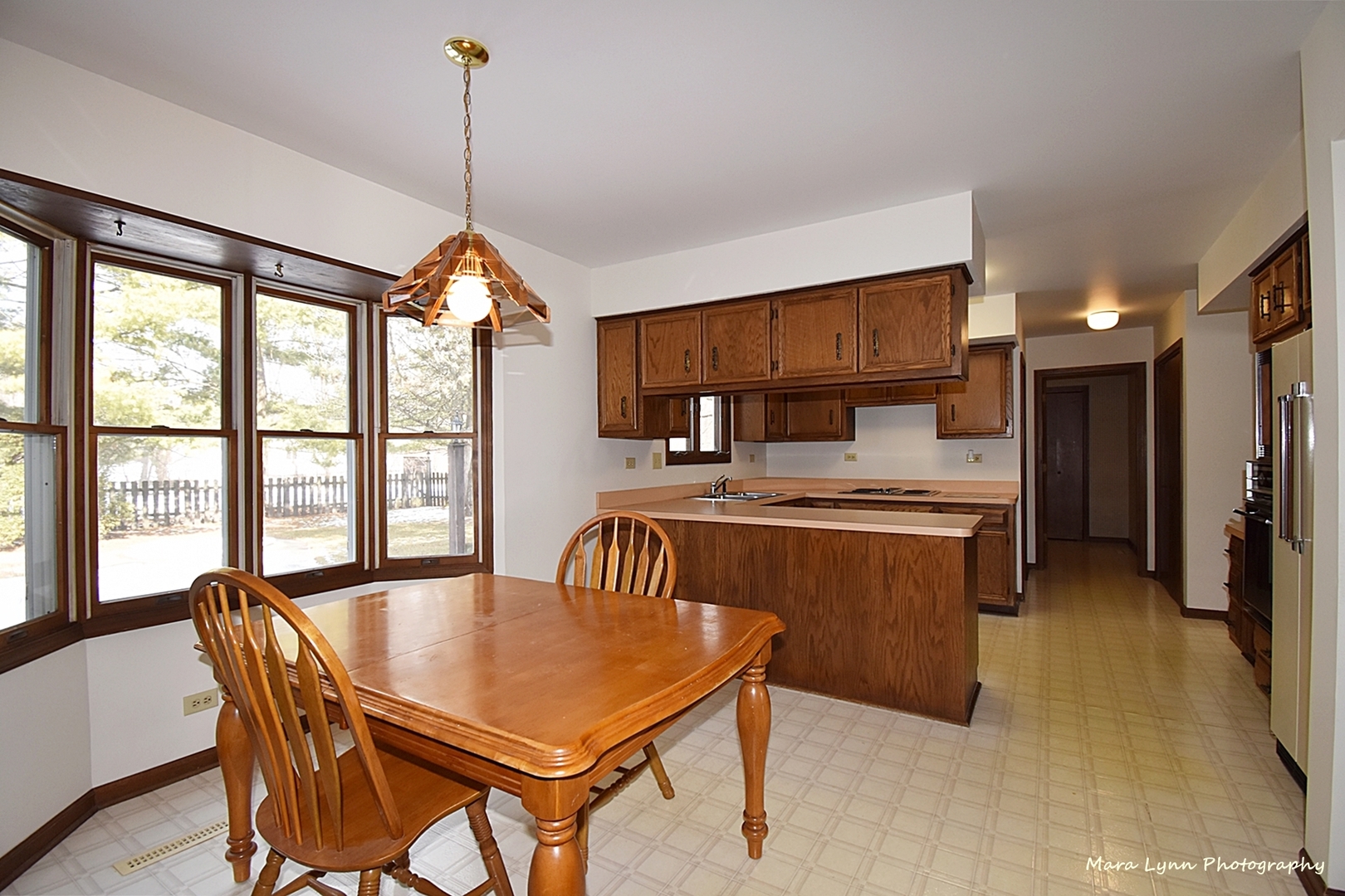 36W818 Oak Road St. Charles, IL 60175 - Photo 10 of 46 a kitchen with a table chairs refrigerator and cabinets