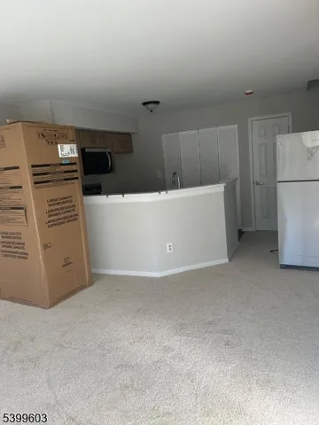 a view of a kitchen with refrigerator and microwave