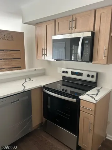 a kitchen with a stove microwave and sink