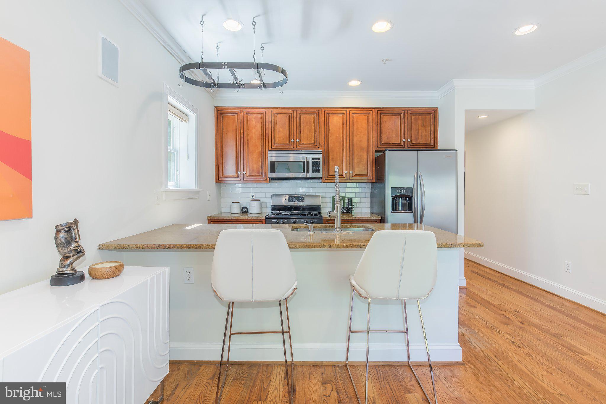 1116 C Street Northeast, Unit 202 Washington, DC 20002 - Photo 12 of 30 Modern kitchen with warm wood accents.